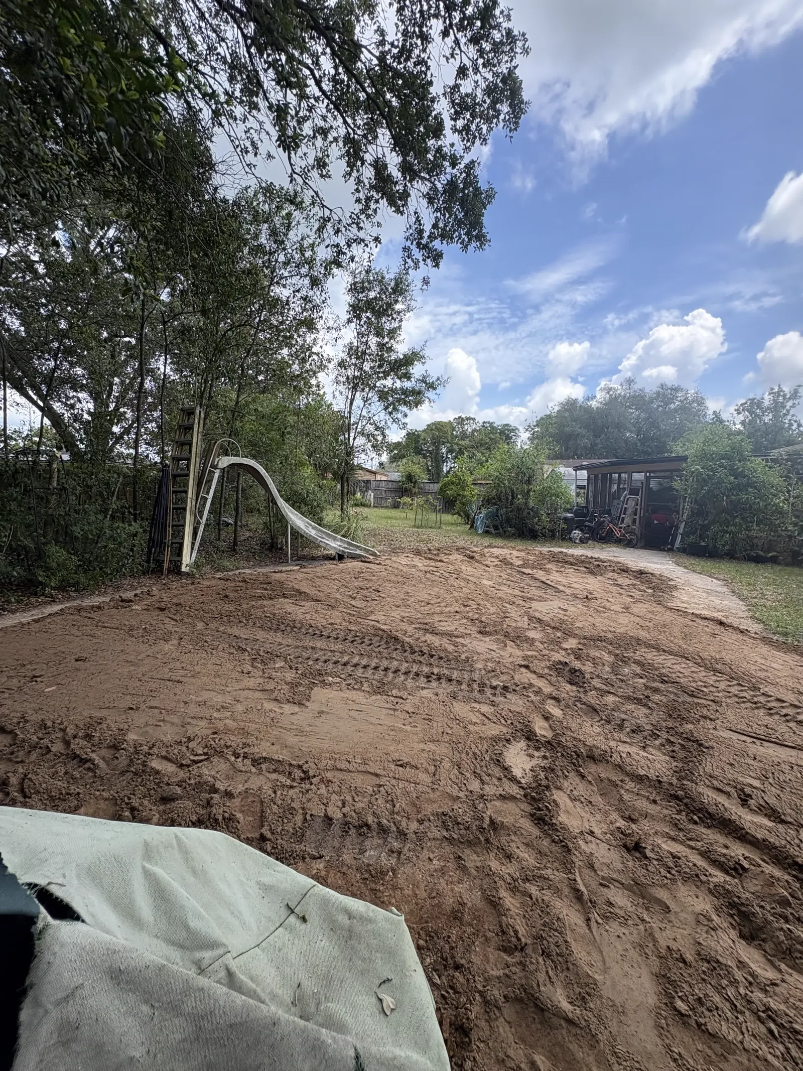 Compacted fill dirt graded smooth in a Middleburg backyard pool fill-in