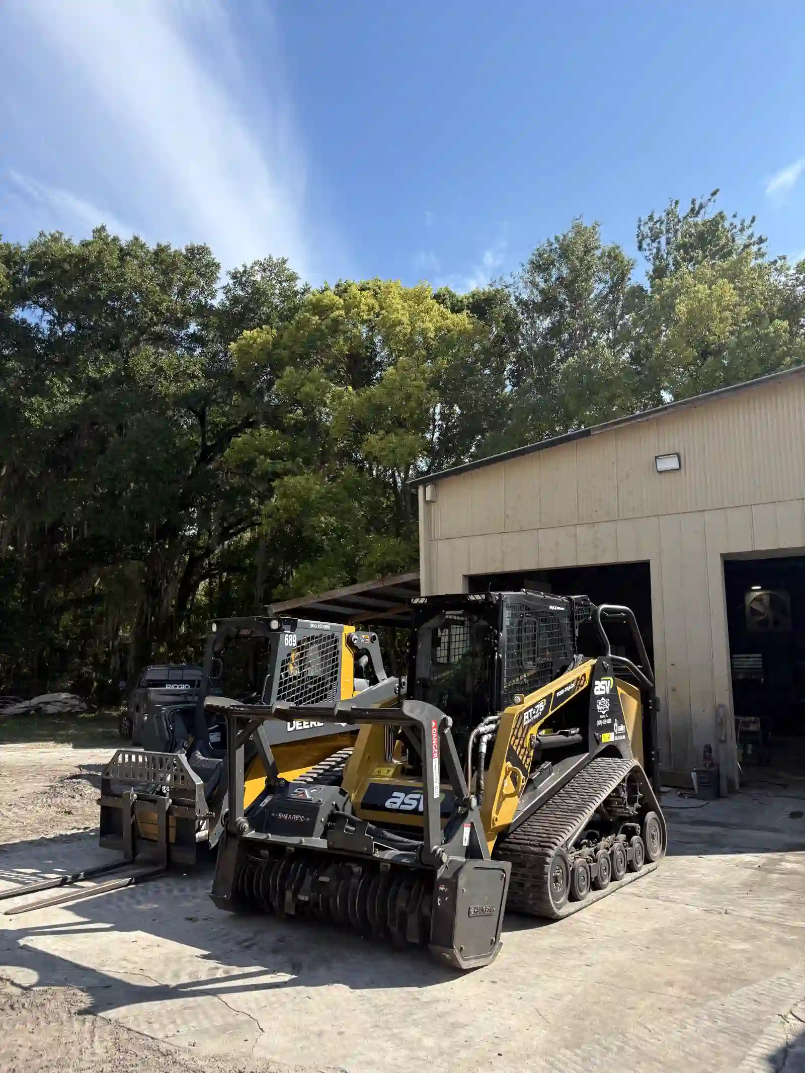 JGH ASV forestry mulcher and skid steer at the shop