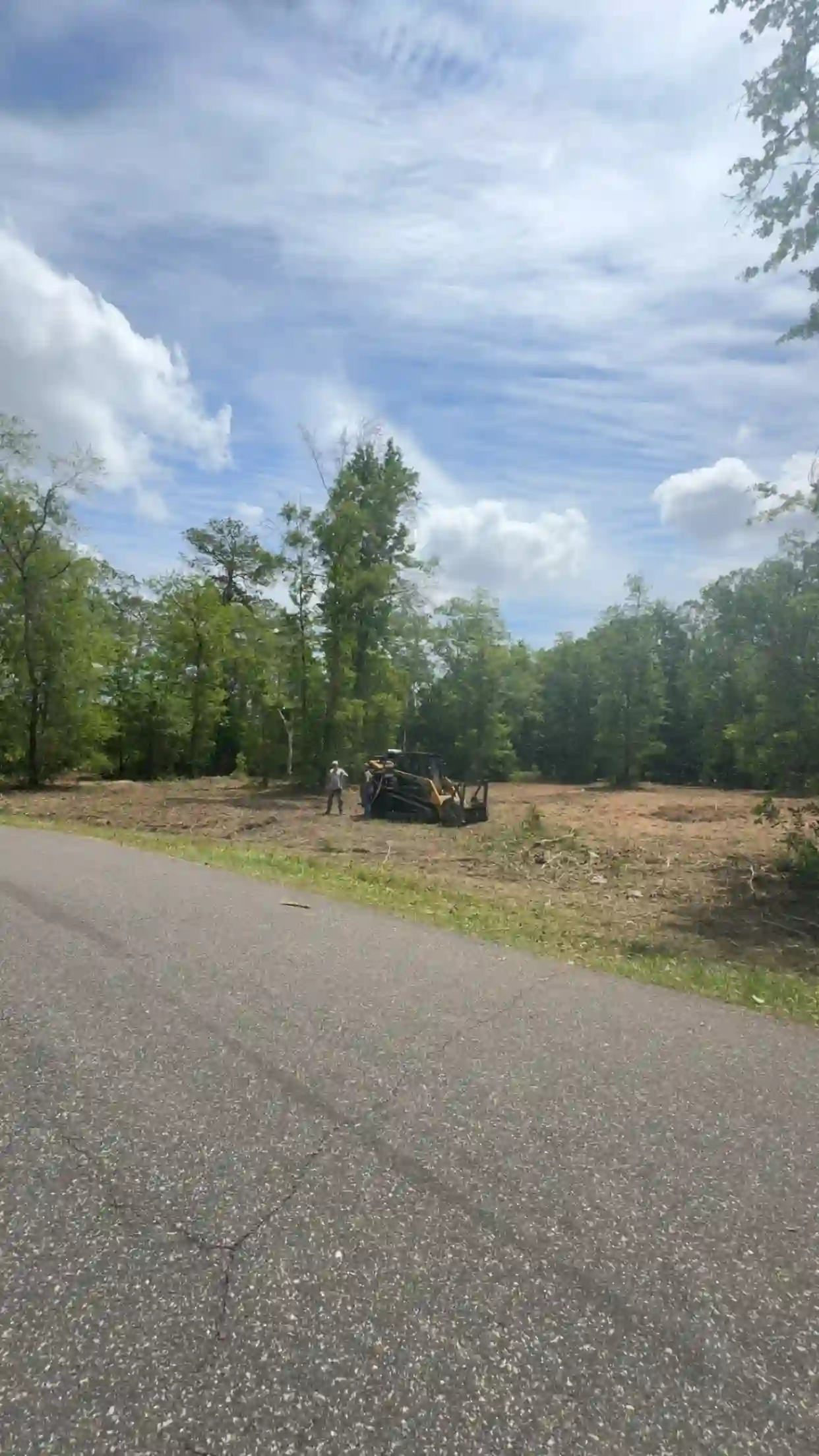 JGH crew and mulching machine on a cleared roadside lot